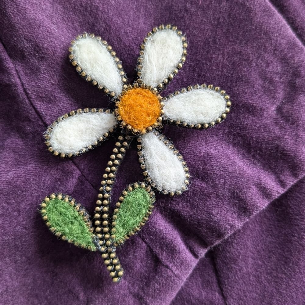 Statement daisy brooch on coat